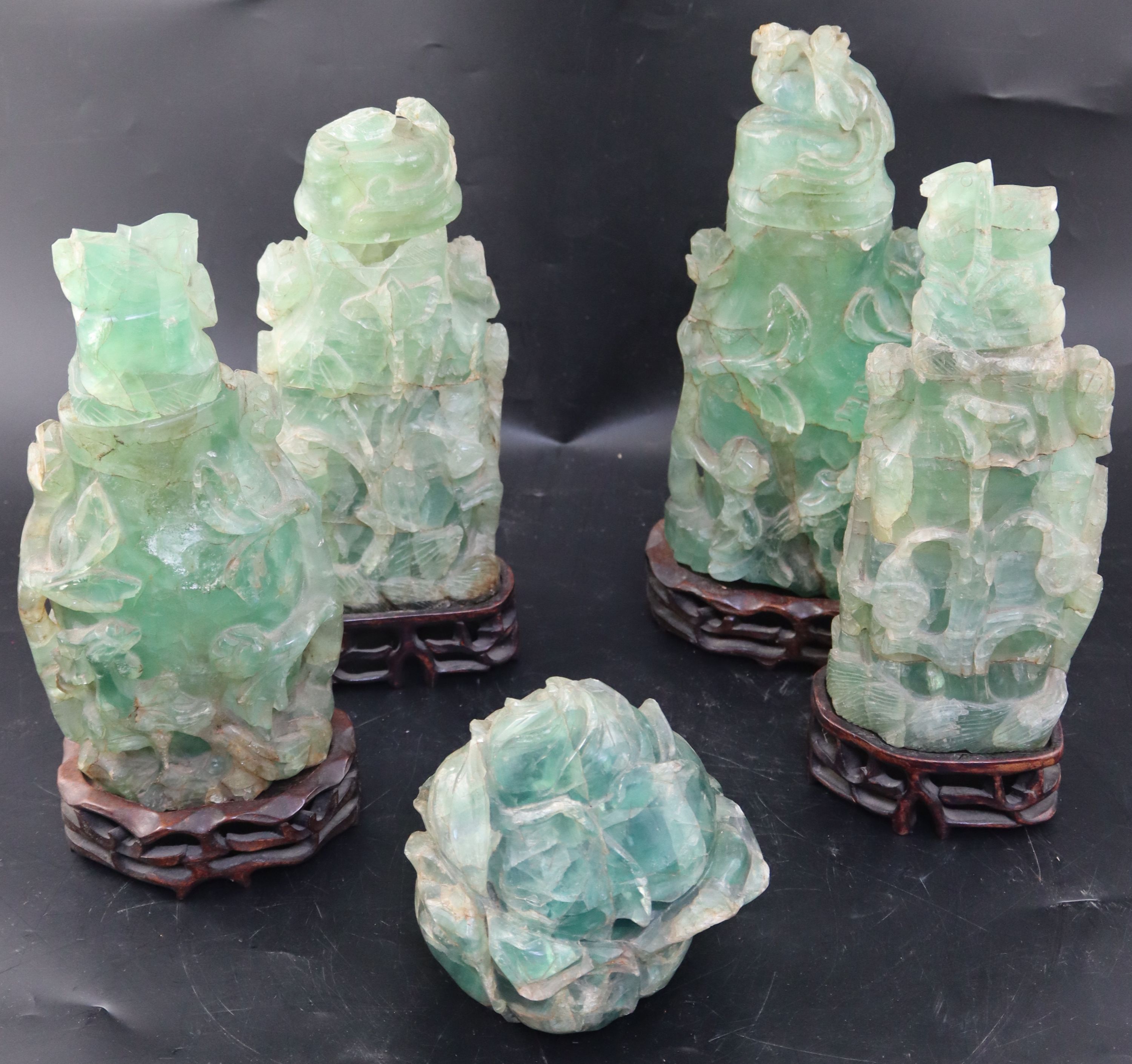 Four late 19th / early 20th century Chinese green quartz vases and covers, largest 27.5cm